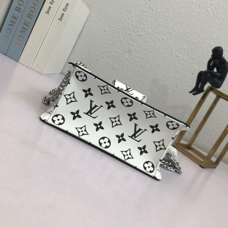 Styled lifestyle shot of refined signature women's handbag – women's luxury handbag