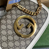 Handle and strap detail of chic polished women's handbag – women's statement bag