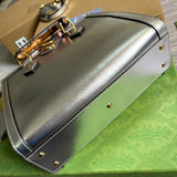 Styled lifestyle shot of refined sleek women's handbag – women's luxury handbag