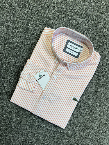 Flat lay presentation of Lacoste luxury clothing with logo-detail design