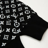 Close-up detail shot of Louis Vuitton luxury clothing with signature branding