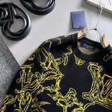 Flat lay presentation of Louis Vuitton luxury clothing with label-forward styling