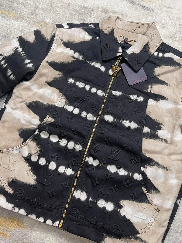 Flat lay presentation of Louis Vuitton luxury clothing with label-forward styling