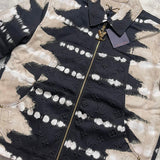 Flat lay presentation of Louis Vuitton luxury clothing with label-forward styling