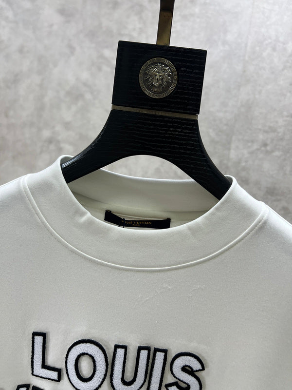 Close-up detail shot of Louis Vuitton luxury clothing with monogram-inspired silhouette