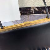 Handle and strap detail of sleek elevated women's handbag – women's statement bag