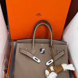  Understated top-handle bag carried on shoulder