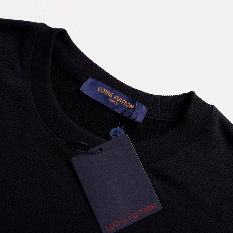 Close-up detail shot of Louis Vuitton luxury clothing with label-forward styling