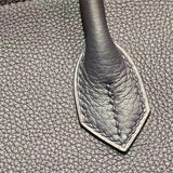 Side view of sleek structured handbag