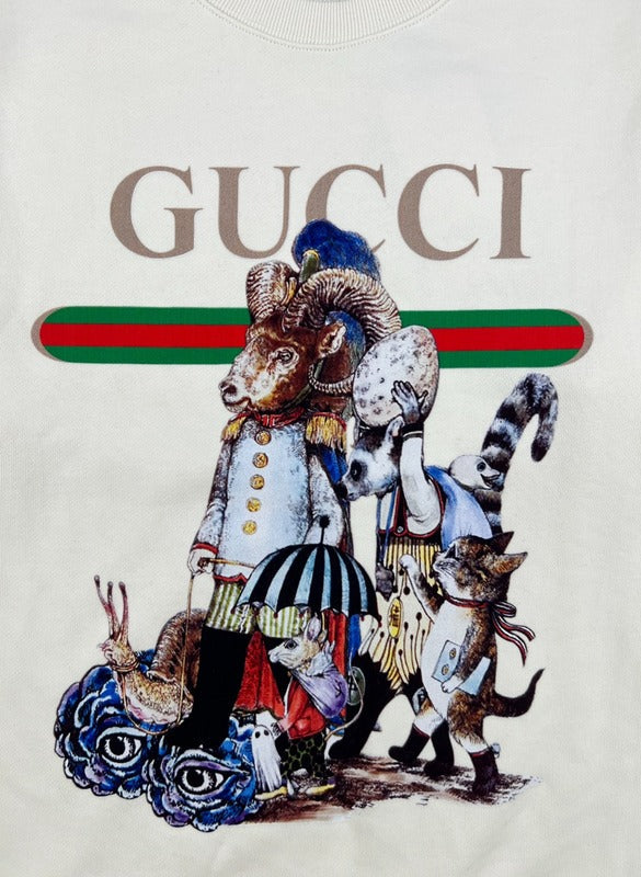 Flat lay presentation of Gucci luxury clothing with signature branding
