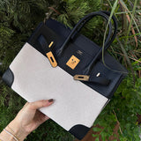 Side view of streamlined structured handbag