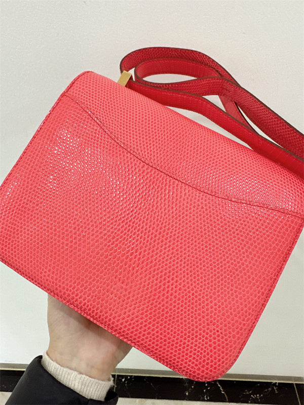  Signature top-handle bag carried on shoulder