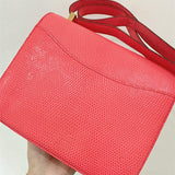 Signature top-handle bag carried on shoulder