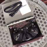 Handle and strap detail of everyday-luxe polished women's handbag – women's luxury accessory