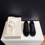 Alexander McQueen tonal black luxury sneakers view 4 classic court silhouette