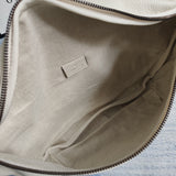 Side profile of signature sleek women's handbag – women's designer-style accessory