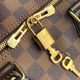 Side profile of polished signature women's handbag – women's luxury handbag