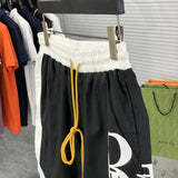 Flat lay presentation of Rhude luxury clothing with label-forward styling