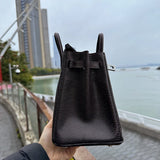 Side view of tailored structured handbag