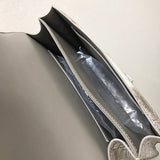 Side view of sculpted structured handbag