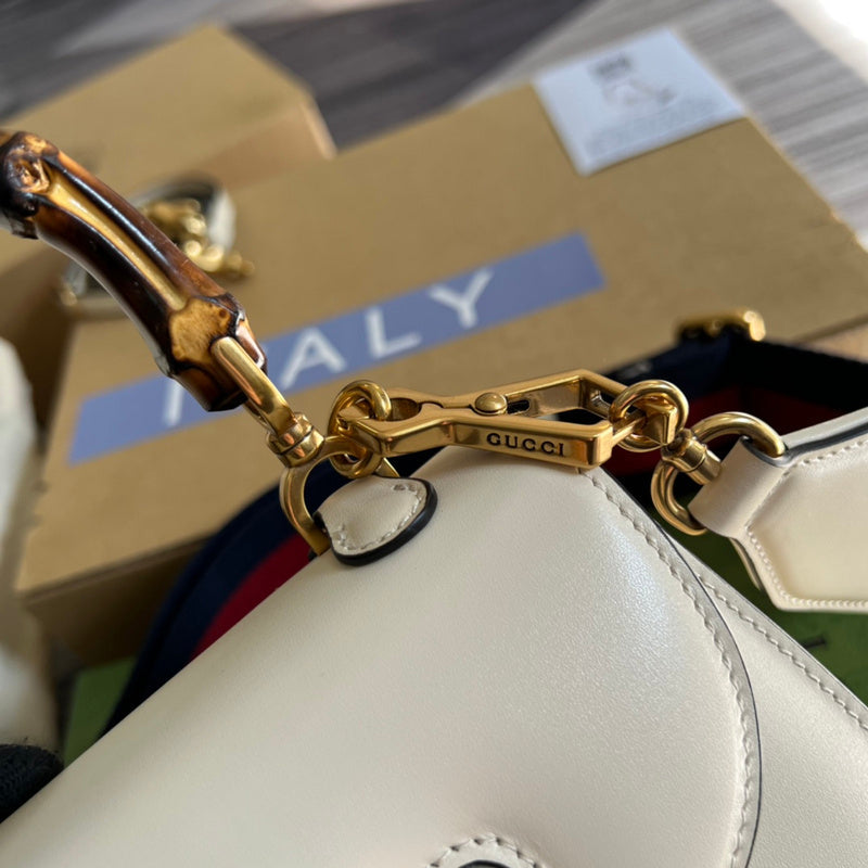 Styled lifestyle shot of sleek structured women's handbag – women's luxury accessory