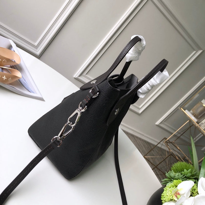 Handle and strap detail of everyday-luxe polished women's handbag – women's luxury handbag
