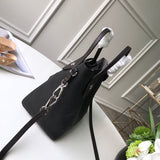 Handle and strap detail of everyday-luxe polished women's handbag – women's luxury handbag