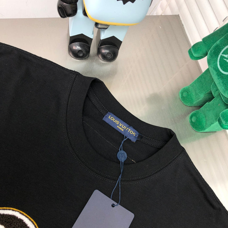 Close-up detail shot of Louis Vuitton cotton t-shirt with label-forward styling