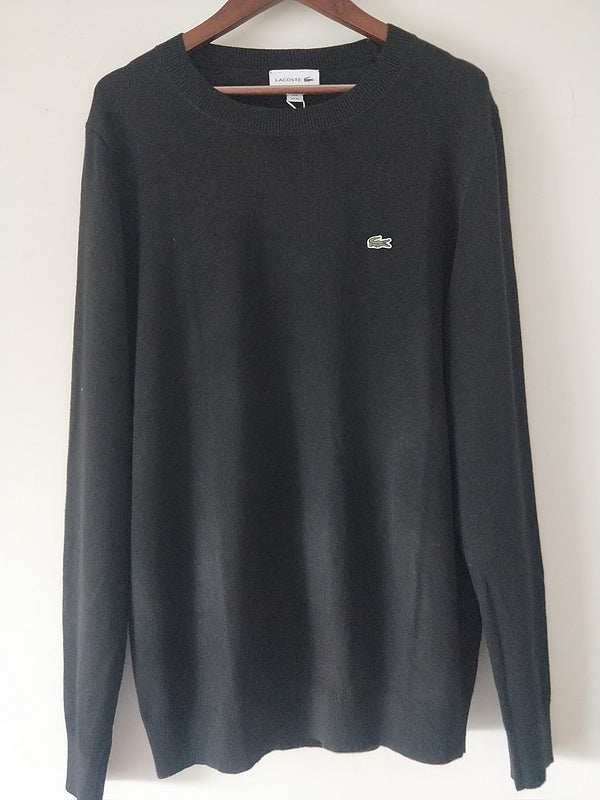 Side profile of Lacoste luxury clothing with monogram-inspired silhouette