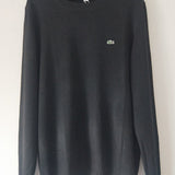 Side profile of Lacoste luxury clothing with monogram-inspired silhouette