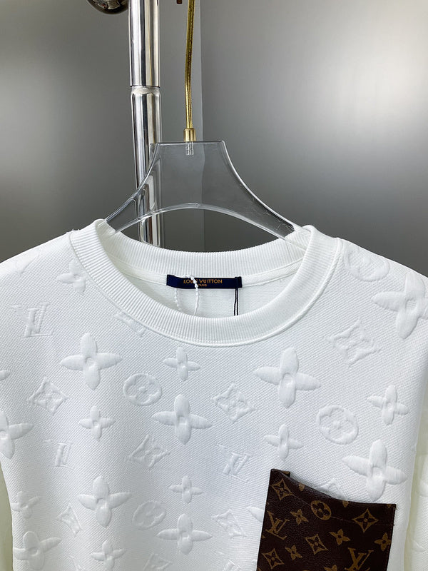 Close-up detail shot of Louis Vuitton luxury clothing with label-forward styling
