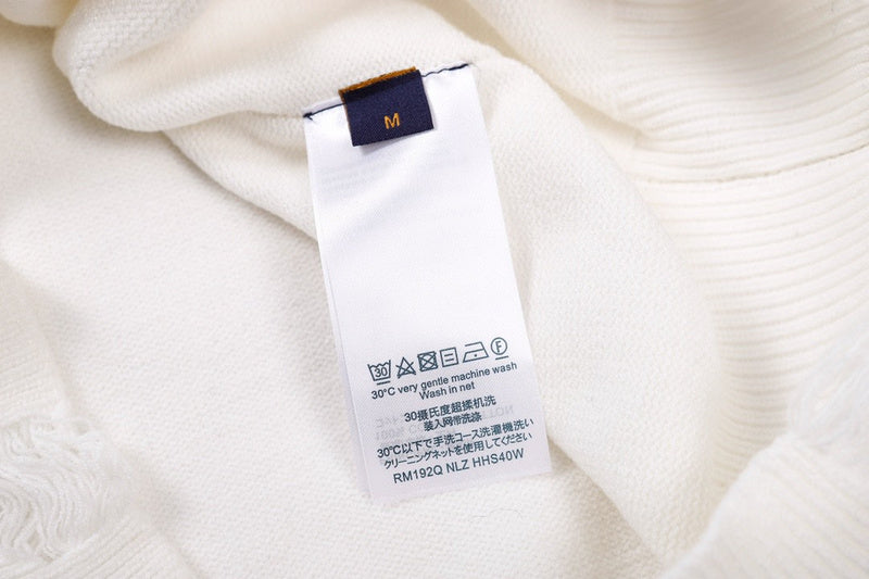 Full styled look of Louis Vuitton luxury clothing with label-forward styling