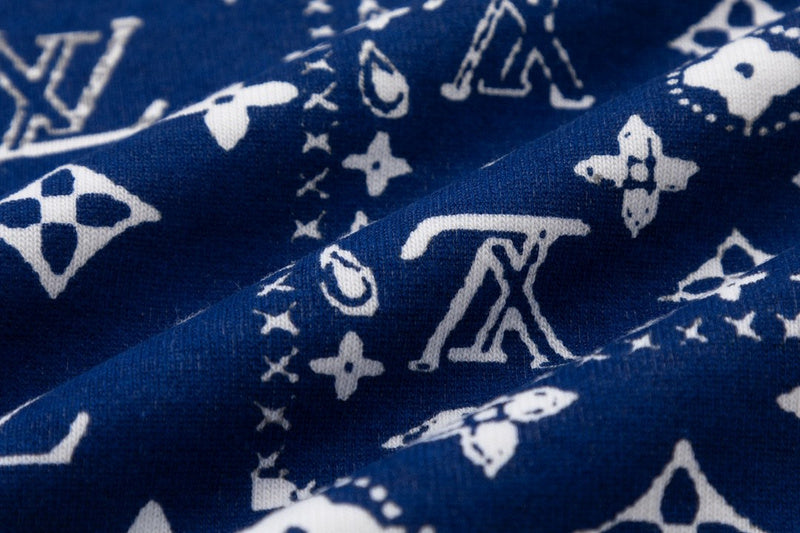Flat lay presentation of Louis Vuitton luxury clothing with signature branding