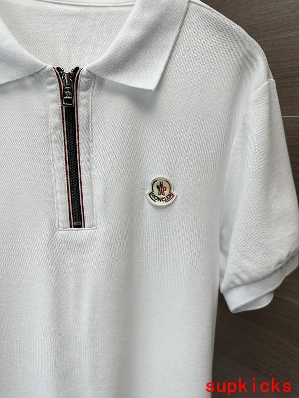 Flat lay presentation of Moncler luxury clothing with signature branding
