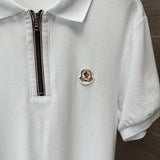 Flat lay presentation of Moncler luxury clothing with signature branding