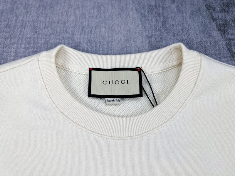 Close-up detail shot of Gucci luxury clothing with signature branding