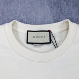 Close-up detail shot of Gucci luxury clothing with signature branding