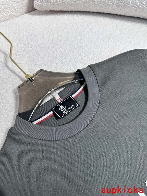 Close-up detail shot of Moncler luxury clothing with signature branding