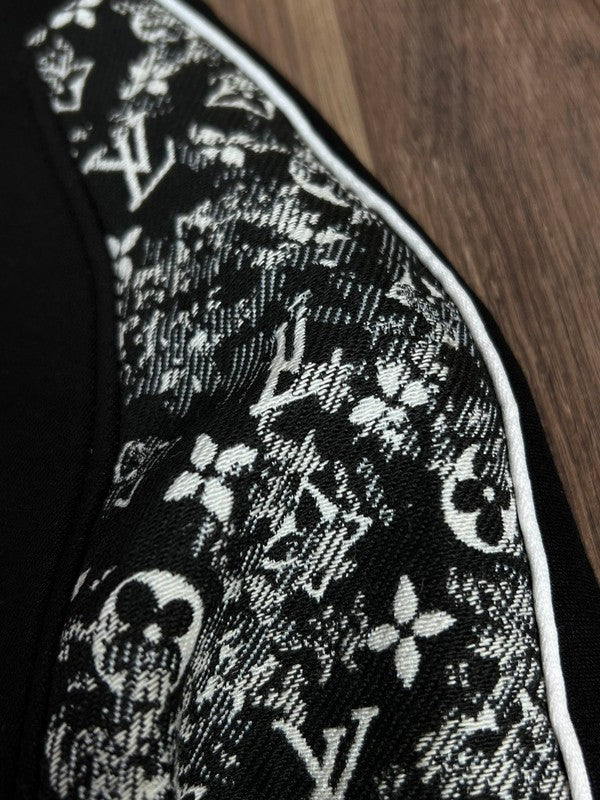 Flat lay presentation of Louis Vuitton luxury clothing with label-forward styling