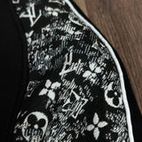 Flat lay presentation of Louis Vuitton luxury clothing with label-forward styling