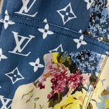 Flat lay presentation of Louis Vuitton luxury clothing with label-forward styling