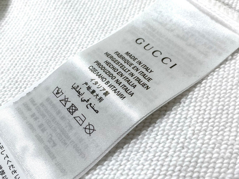 Close-up detail shot of Gucci luxury clothing with relaxed-fit cut