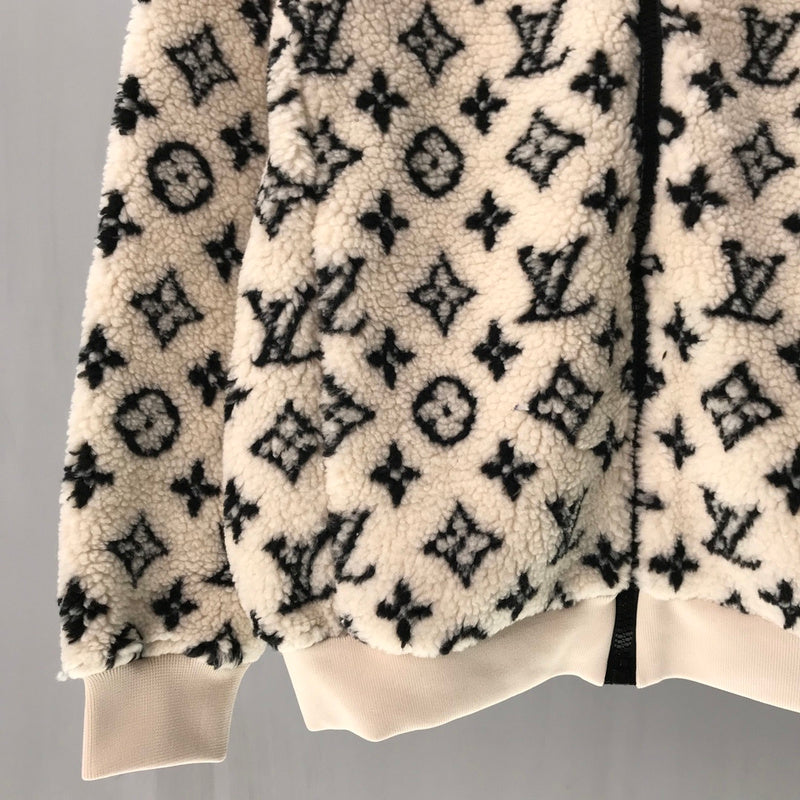 Flat lay presentation of Louis Vuitton luxury clothing with logo-detail design