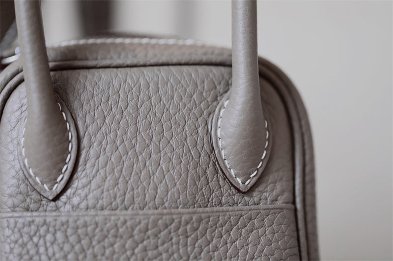 Side view of curated structured handbag
