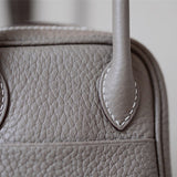 Side view of curated structured handbag