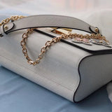 Side profile of refined modern women's handbag – women's luxury accessory