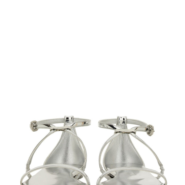 Close-up of Alexander McQueen sandals hardware and fine stitching