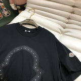 Close-up detail shot of Moncler luxury clothing with monogram-inspired silhouette