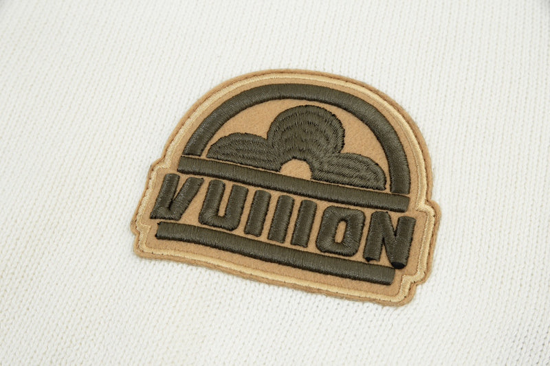 Flat lay presentation of Louis Vuitton luxury clothing with label-forward styling