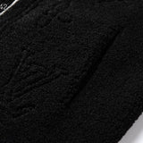 Close-up detail shot of Louis Vuitton luxury clothing with signature branding